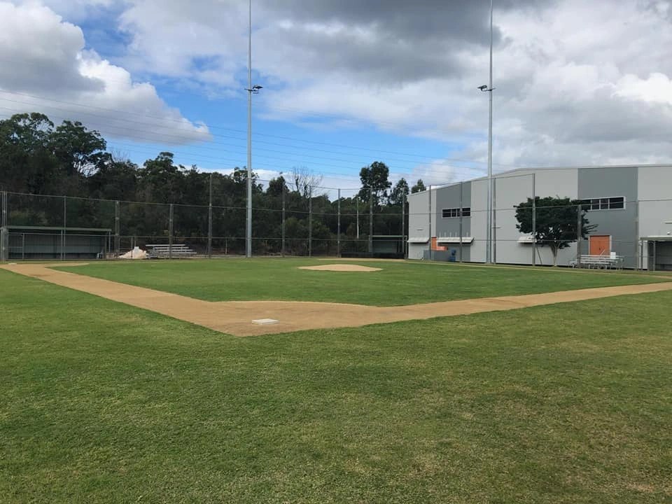 The baseball diamond at Eagles Sports Complex with floodlights, dugouts and a well-kept infield.